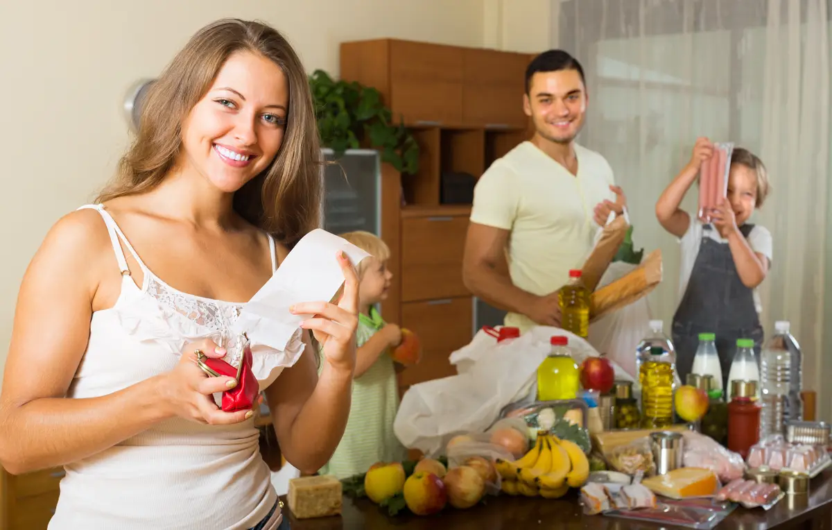 Family of four with bags of food