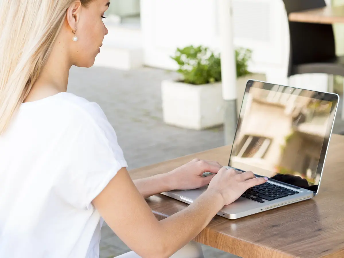 Side view of woman working on laptop