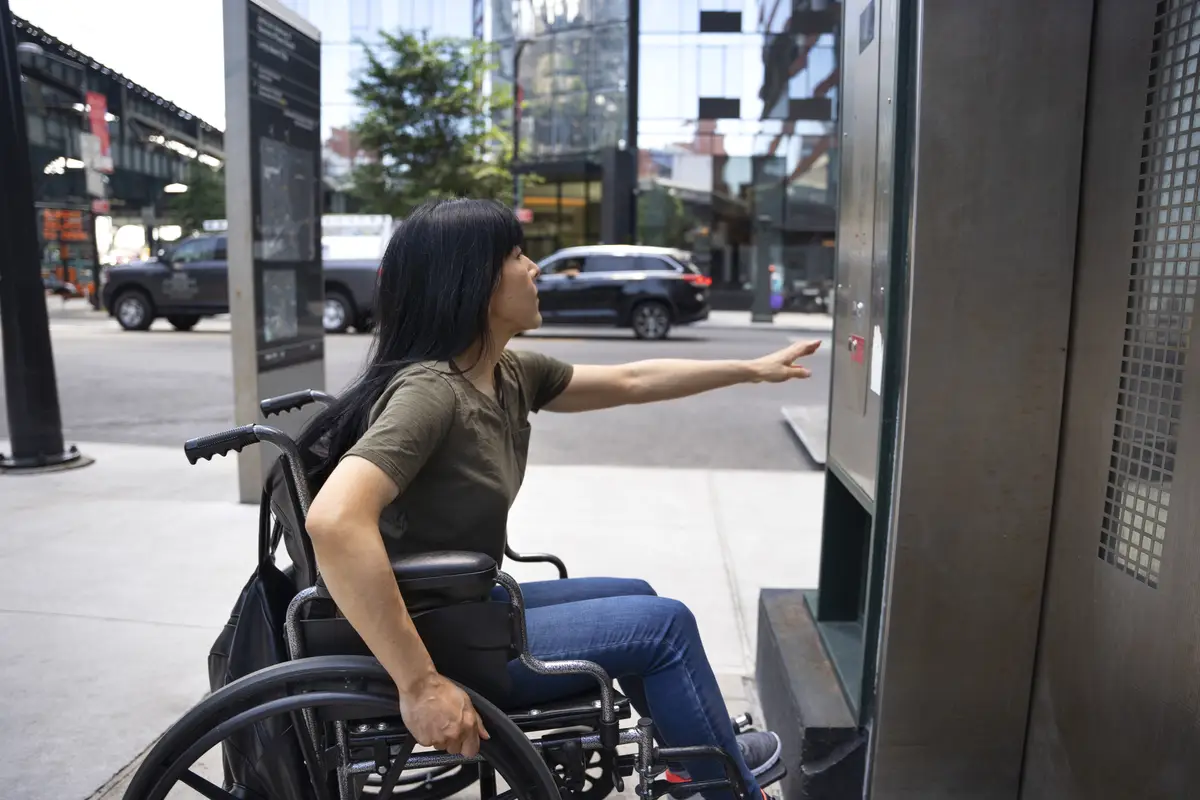 Side view disabled woman by the elevator