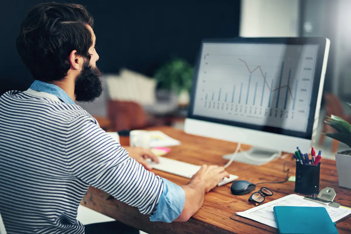 Business man financial graph and computer with digital work for online investment data Finance employee internet and web chart of a worker looking at stock market information for company job