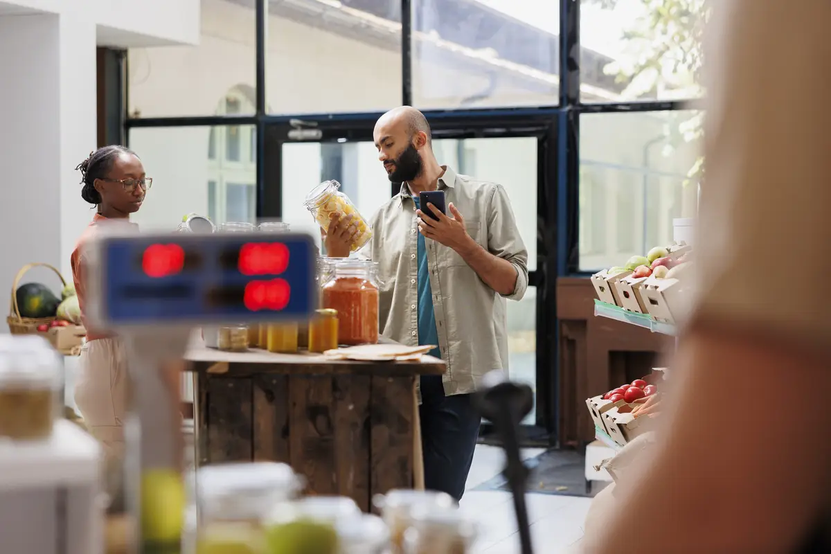 Customer using phone in local store