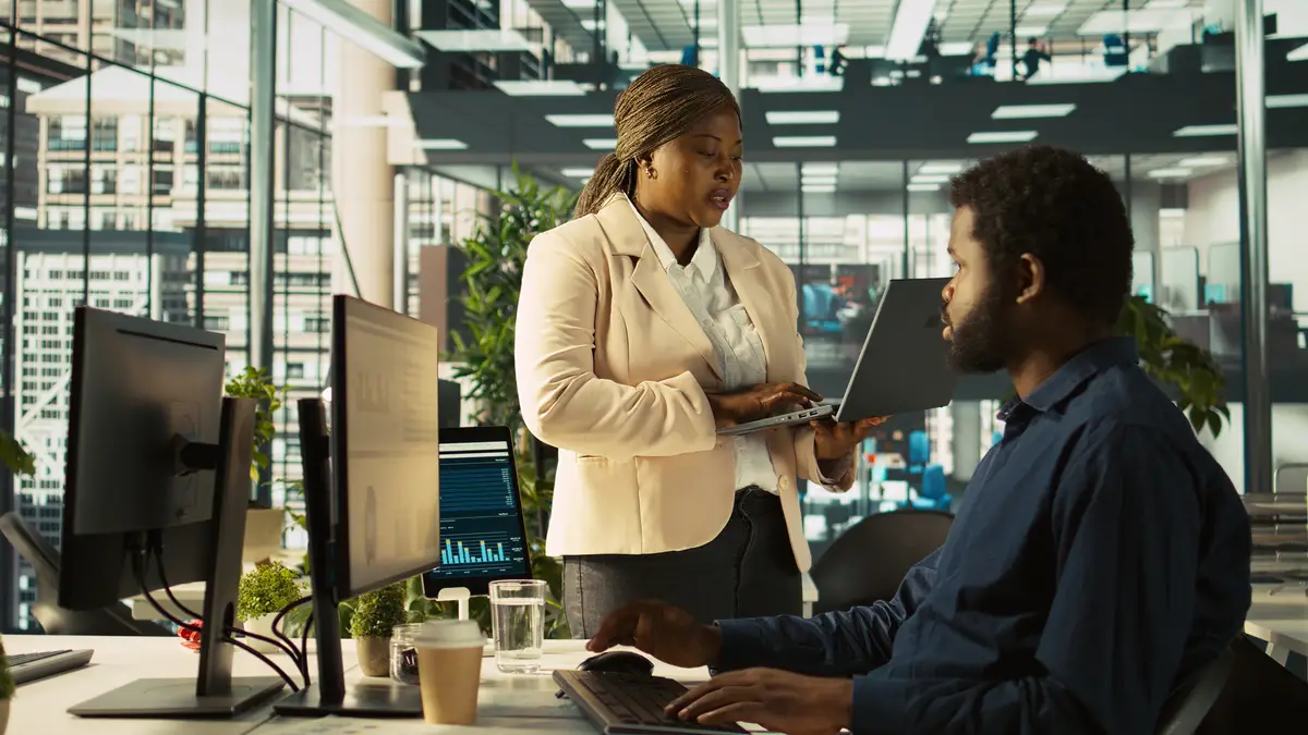 Worker in office receiving feedback from management executive