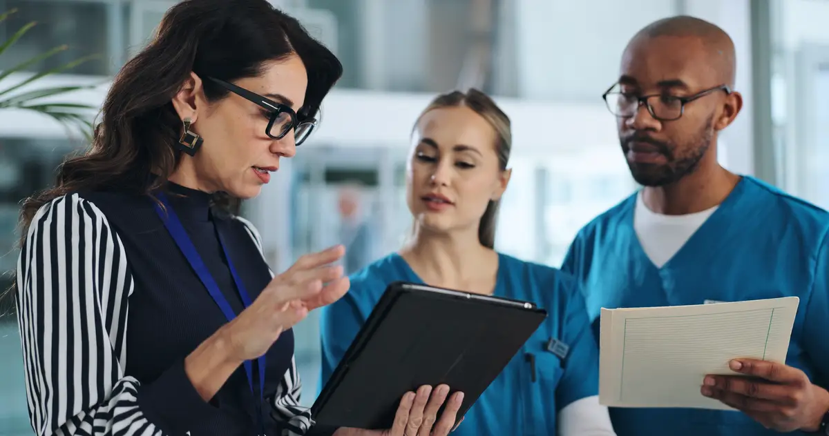 Medical team tablet and meeting in clinic for advice innovation and feedback with patient report Hospital CEO people or tech in lobby with results solution or professional opinion for healthcare