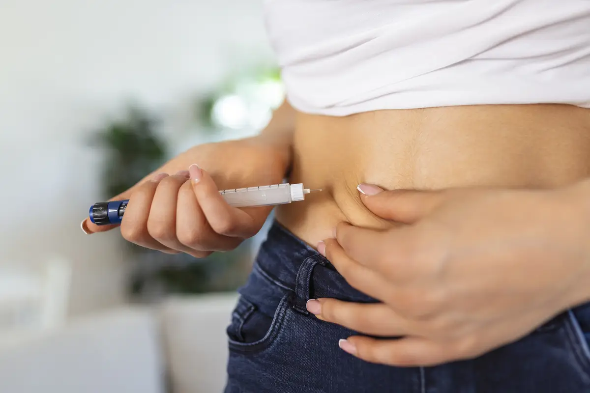 A diabetic patient using insulin pen for making an insulin injection at home Young woman control diabetes Diabetic lifestyle