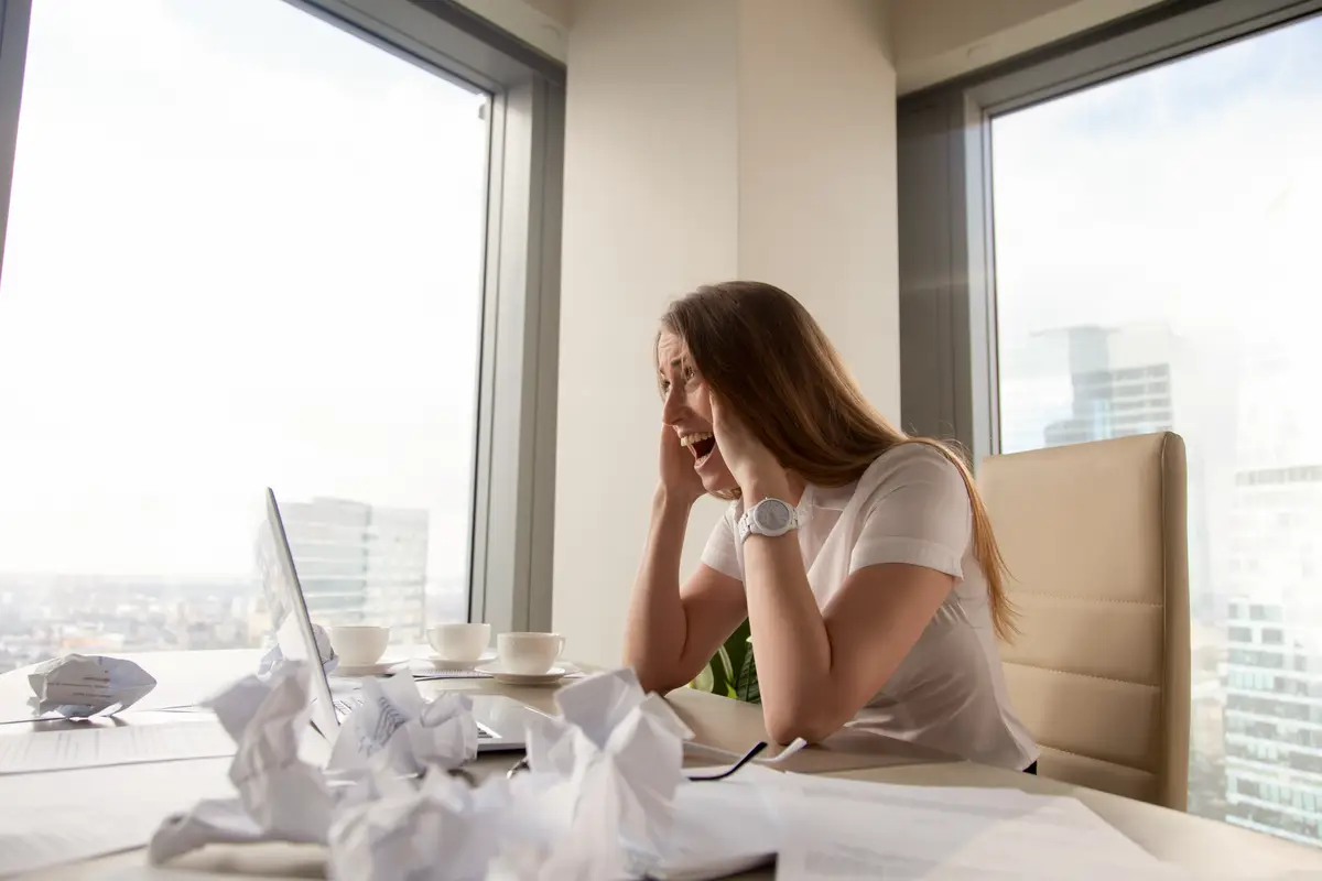 Stressed businesswoman screaming at workplace