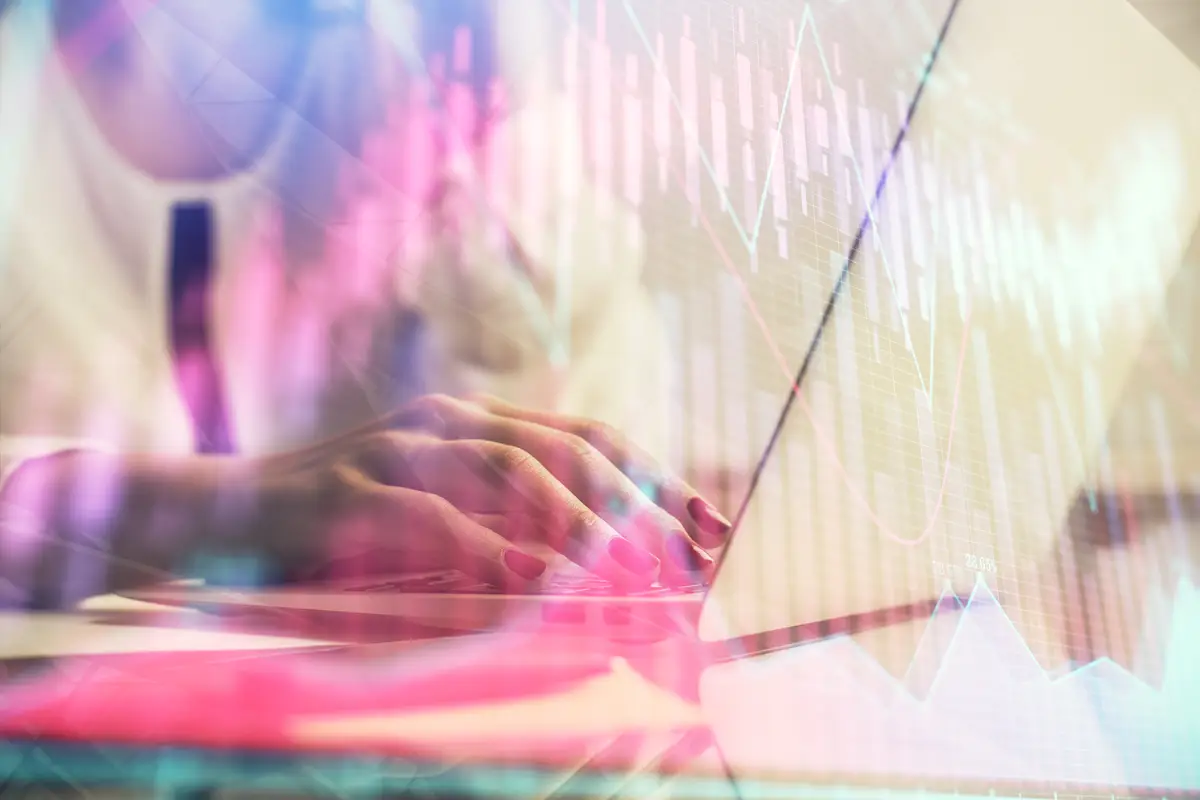 Multi exposure of woman hands typing on computer and financial graph hologram drawing Stock market analysis concept