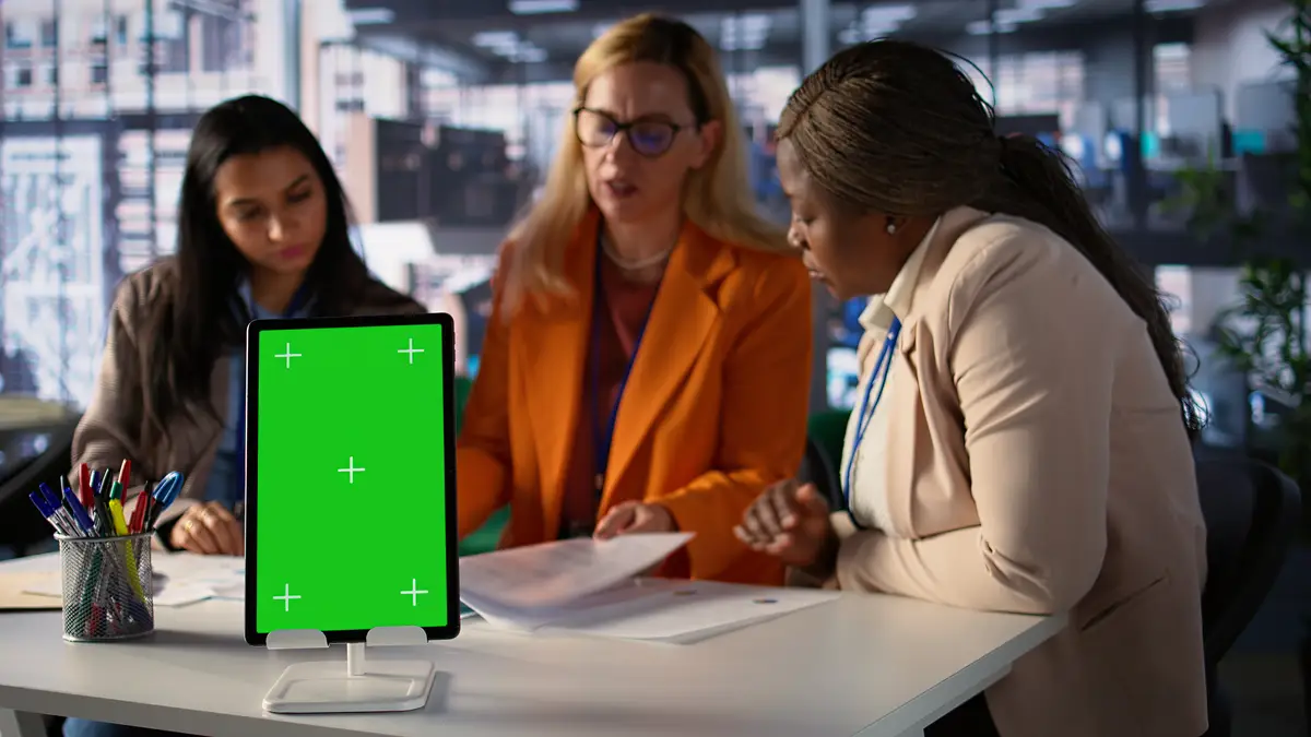 Entrepreneurs team with a success story work next to green screen