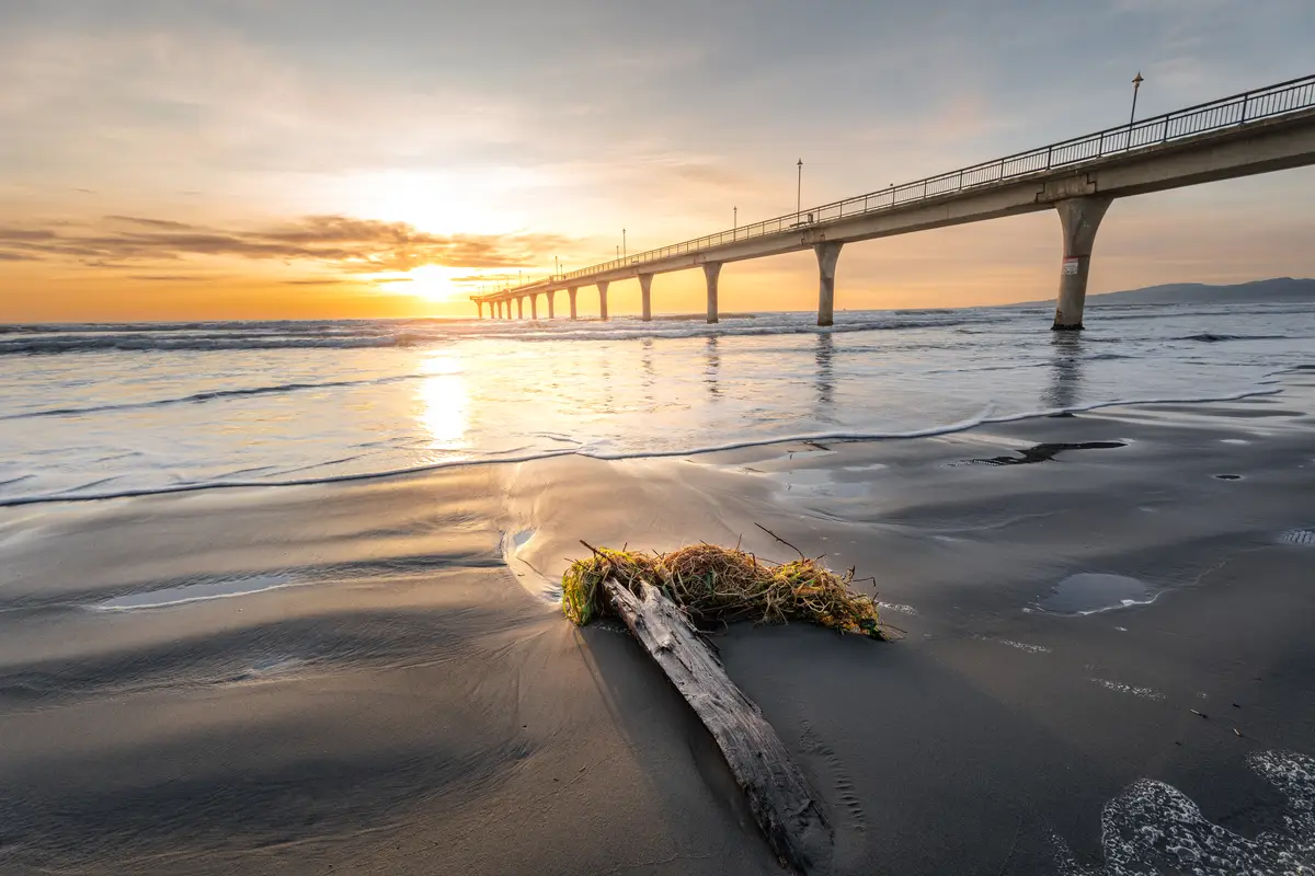 Beautiful sunrise over the new brighton pier at christchurch new zealand