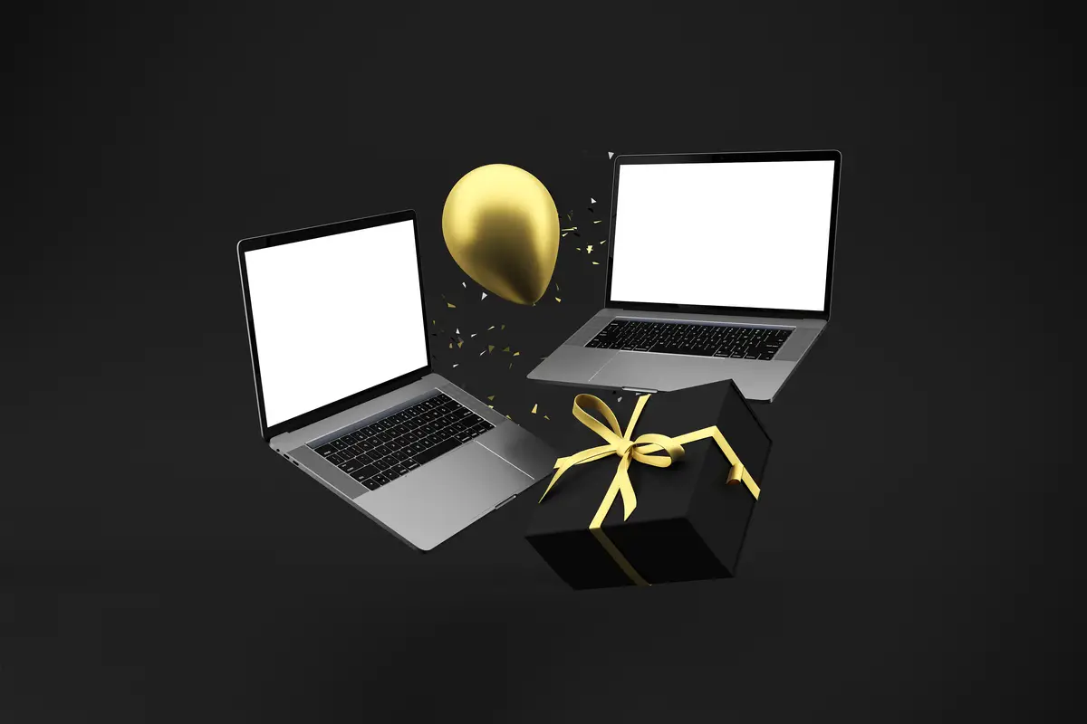 Laptop and Gift with Golden Balloon on Black Background