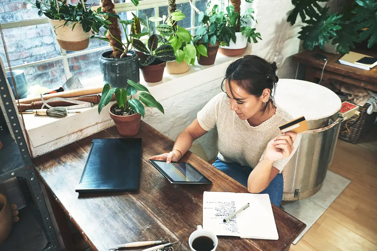 Above woman and tablet with credit card at store of online shopping order supplies and payment Female person digital and ecommerce for transaction password upgrade inventory and pottery expenses