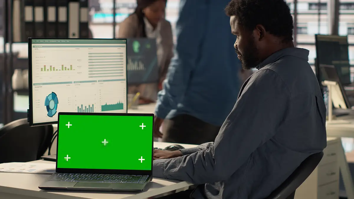 Male general manager looking at mockup screen and solving tasks