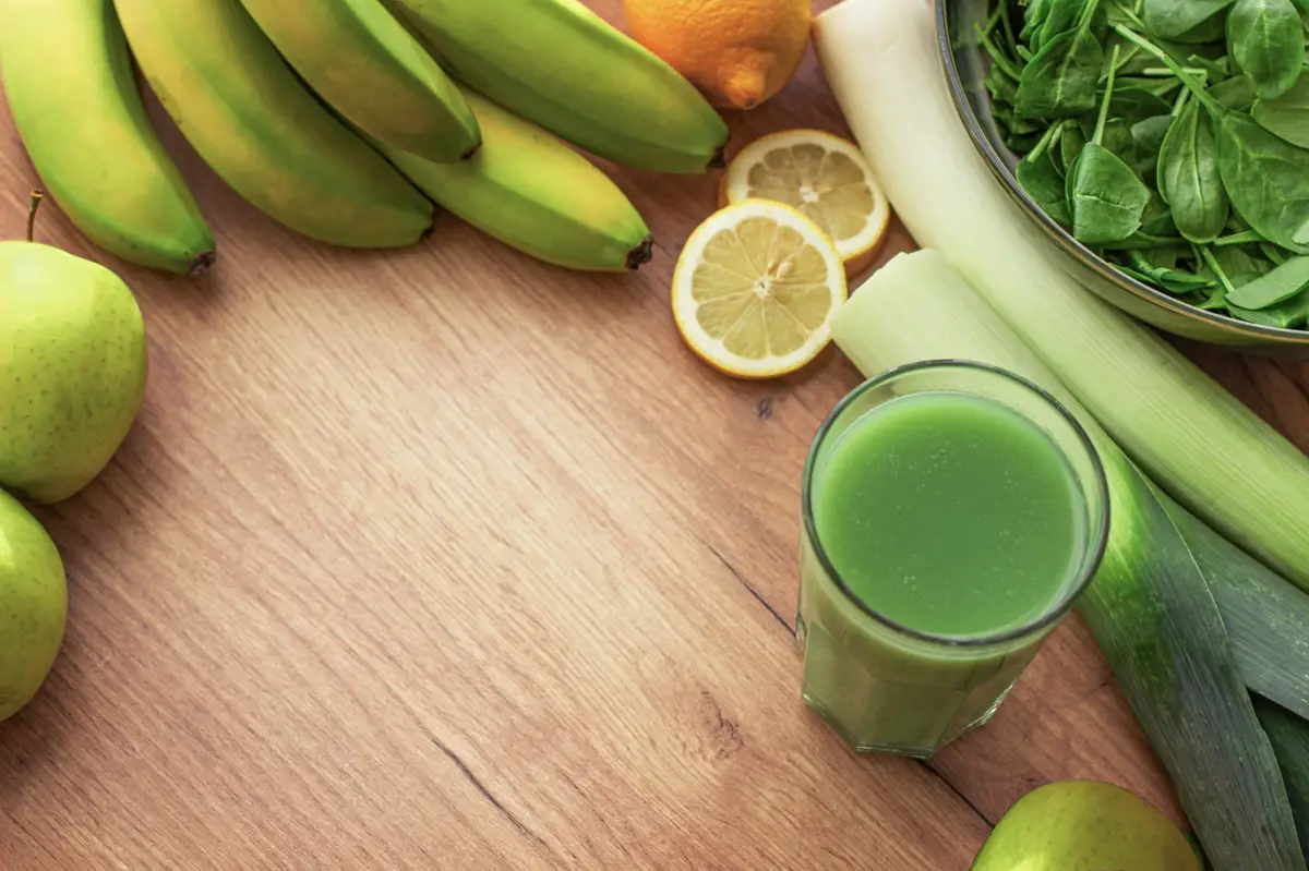 Fruits and vegetables for smoothies on a wooden background Background with space for text