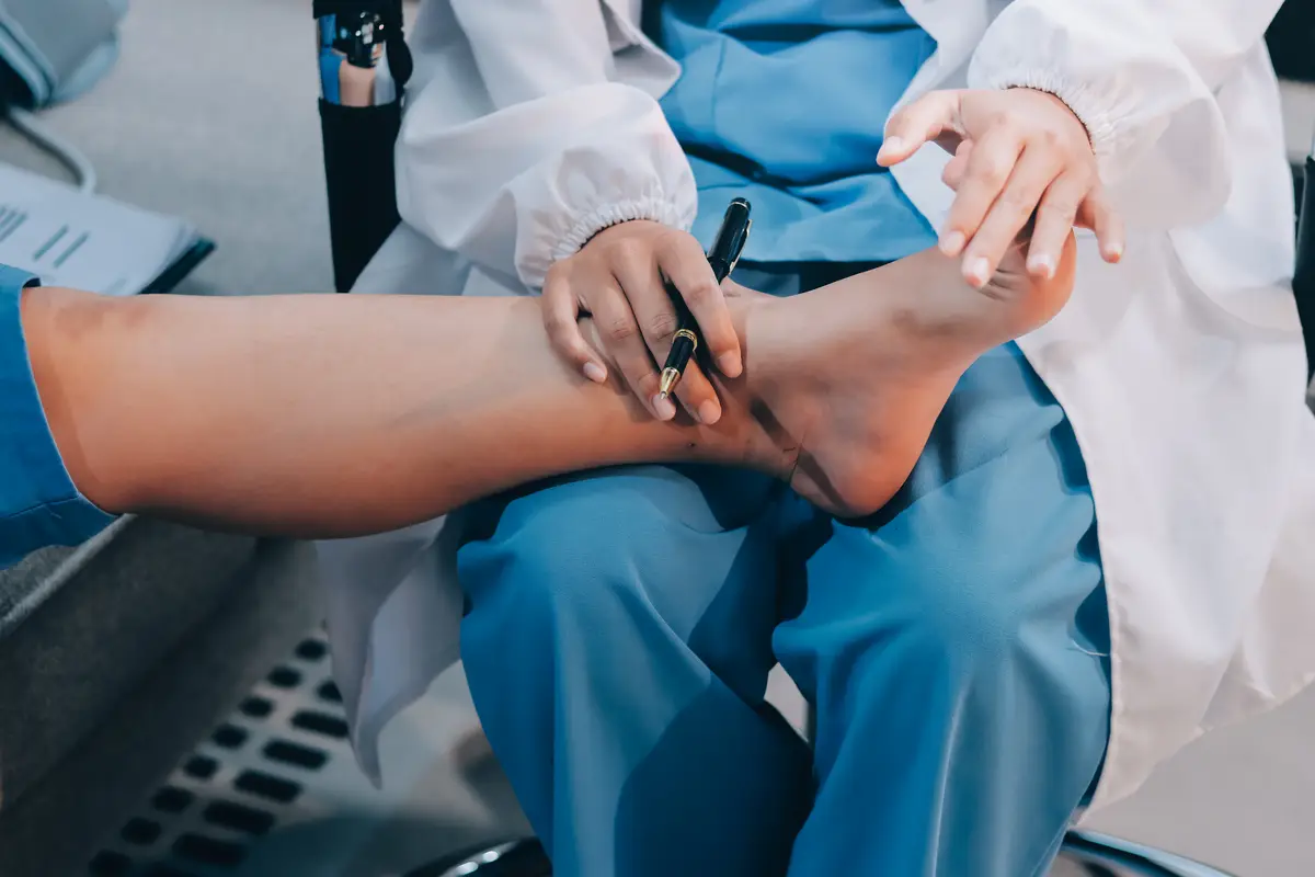 Doctor giving a patient a leg treatment