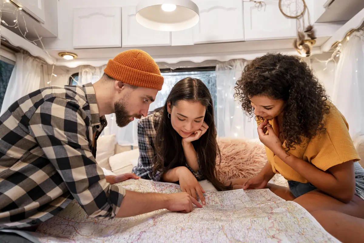Friends looking on a map in the van