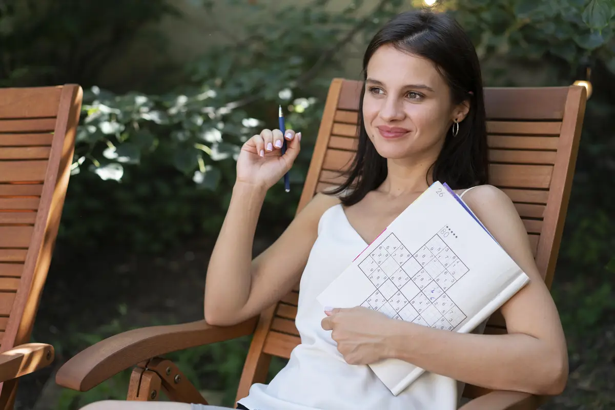 Woman enjoying a sudoku game on paper by herself
