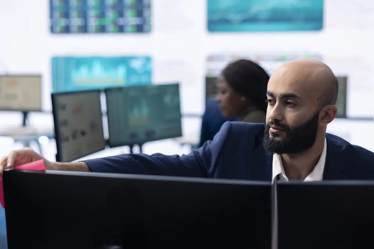 Enterprise manager looking into project updates and details in monitoring room