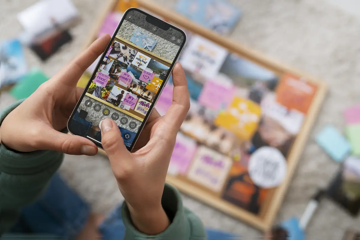 Woman creating inspiring vision board top view