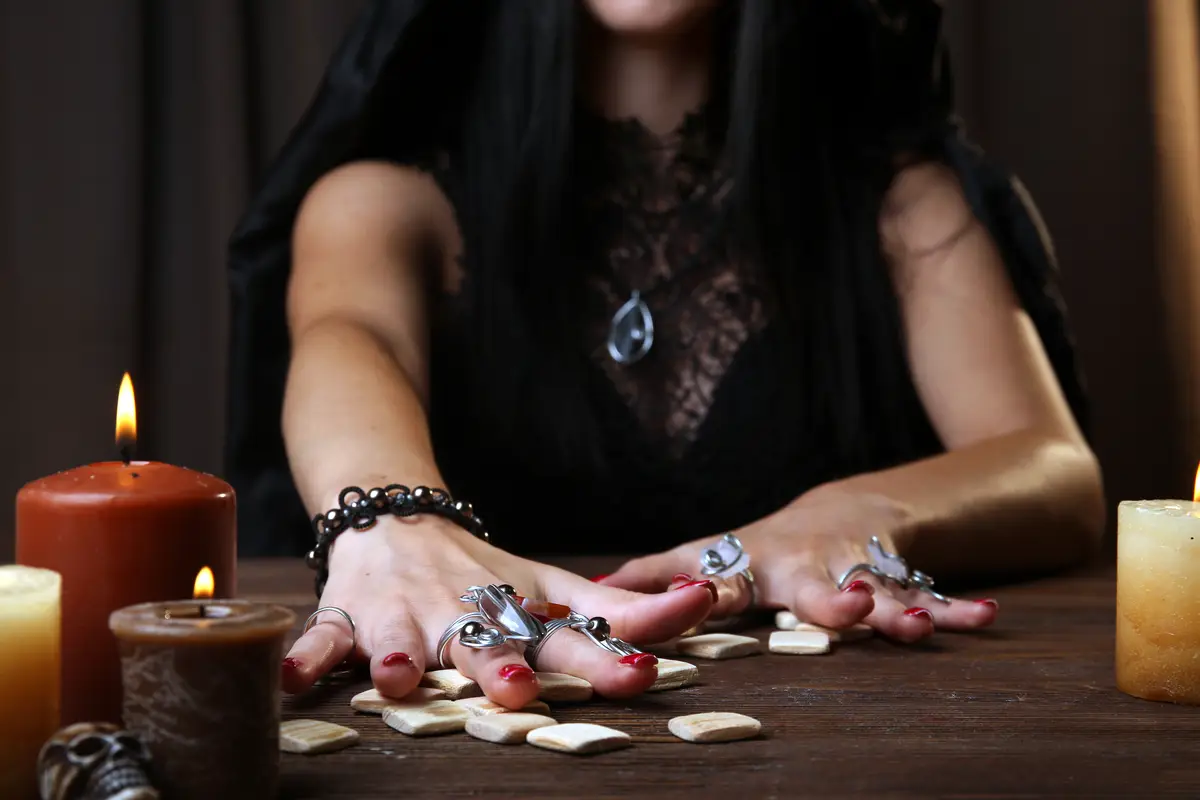 Witch fortune teller on dark background