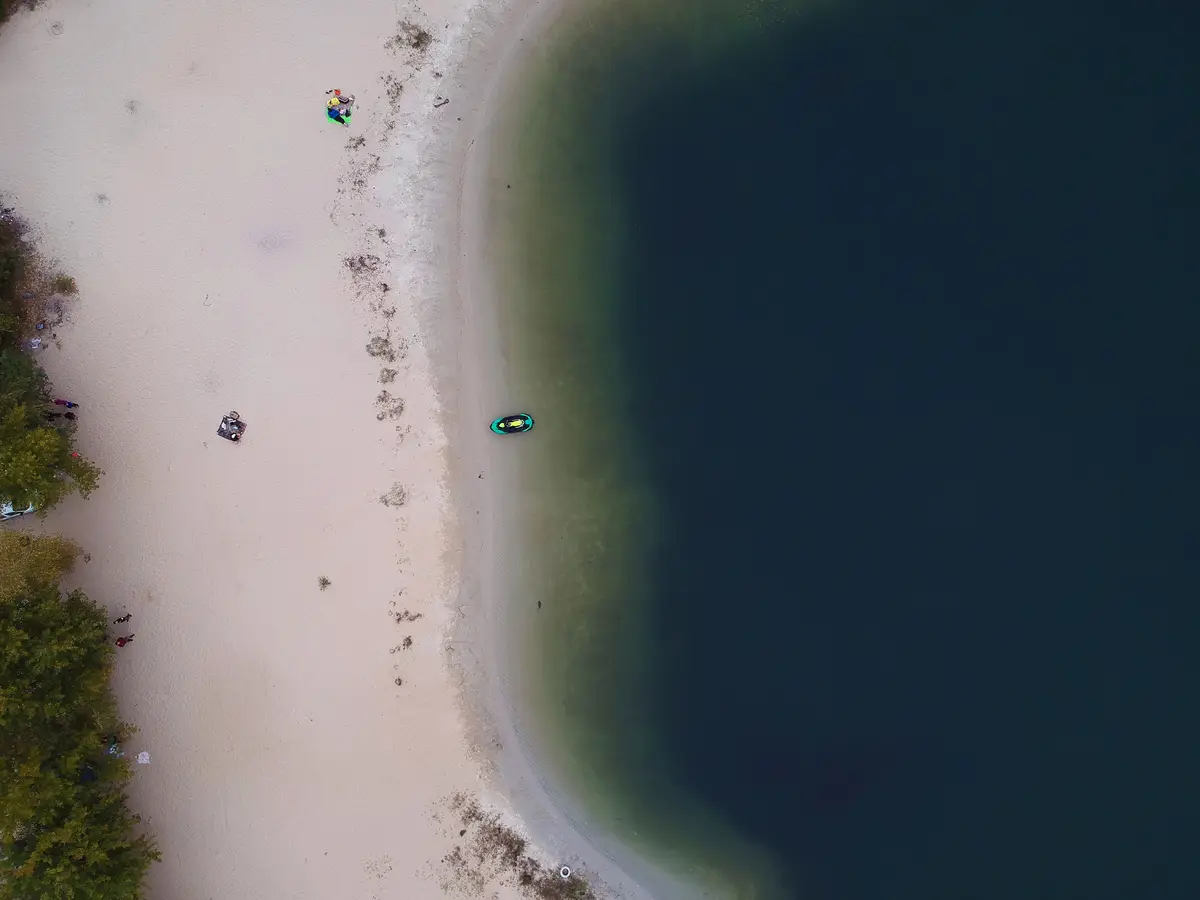 Aerial summer view of empty beach of lake. Drone photo.