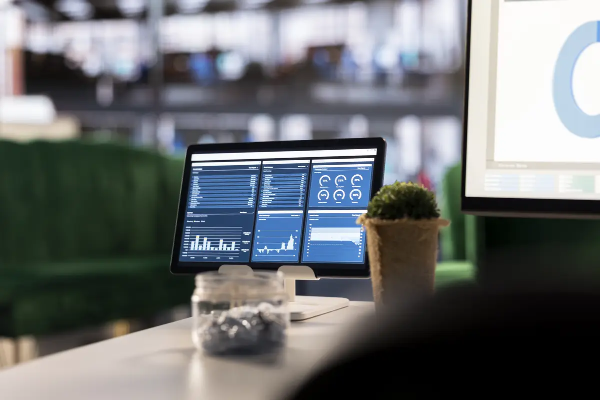 Executive workspace features a digital dashboard with financial charts