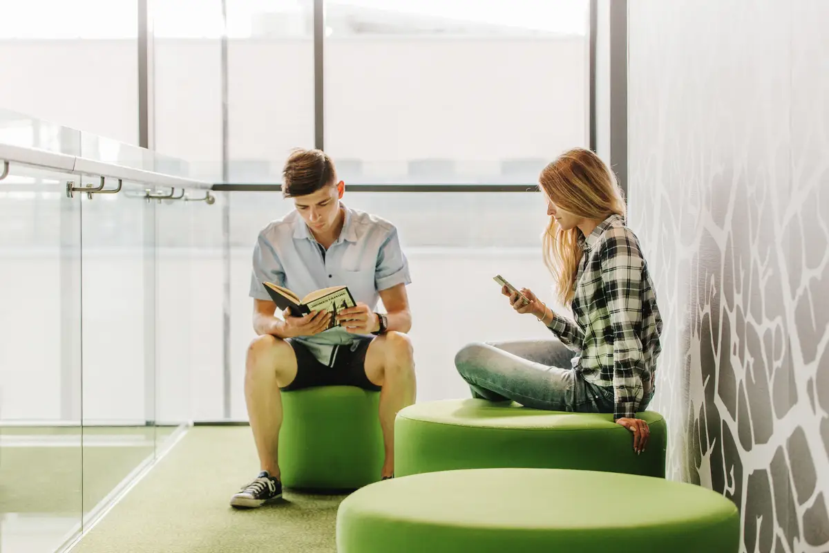 Youngsters with book and phone