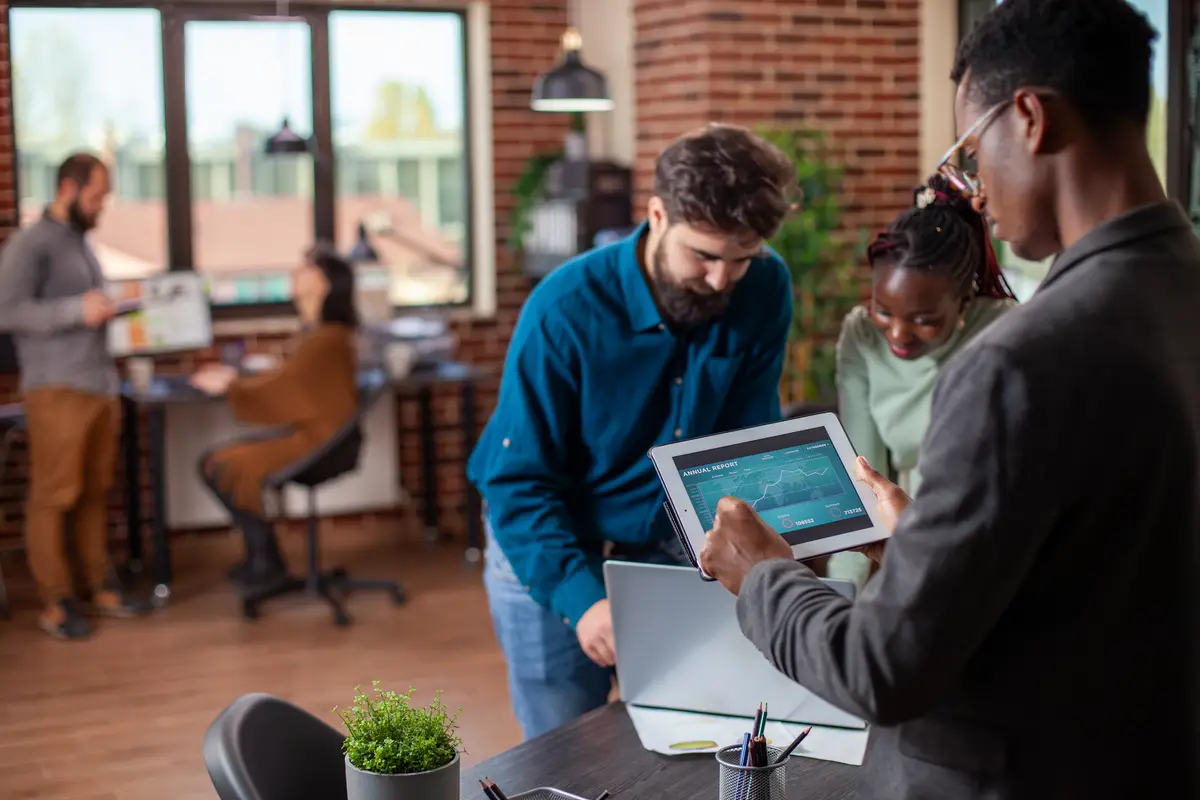 Businessman checking report on tablet
