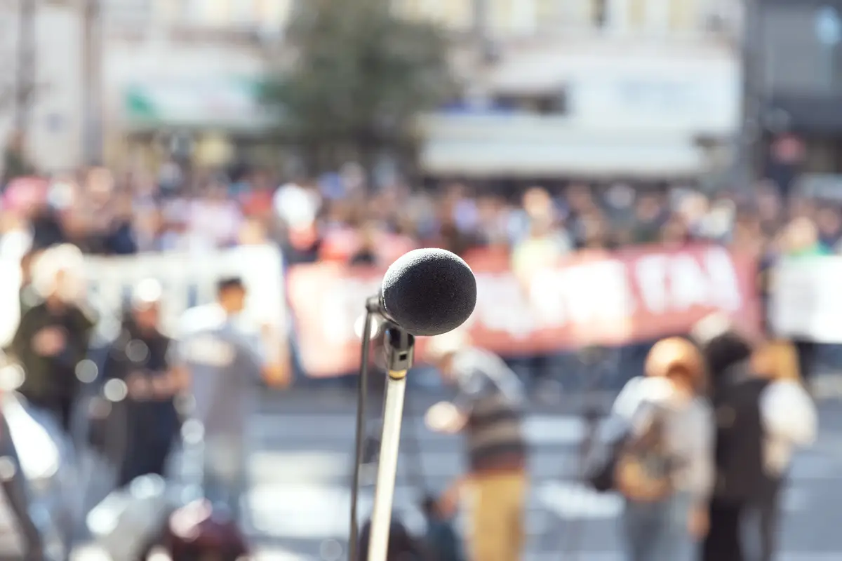 Focus on microphone blurred crowd of people in the background