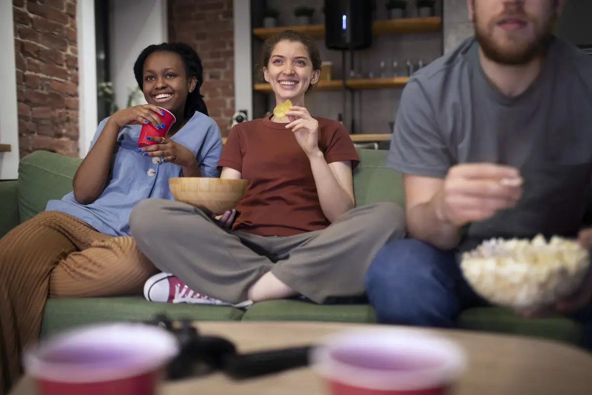 Smiley people sitting on couch front view