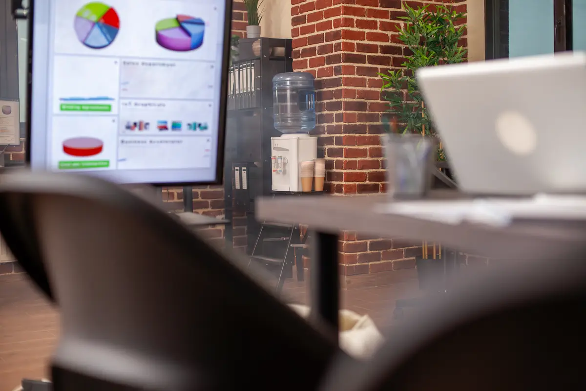 Devices and water cooler in empty office