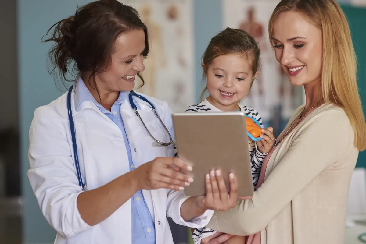 Cute toddler with her mother at the doctor