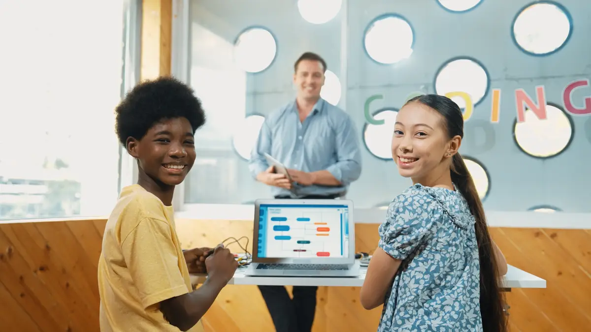 Highschool student study programing system while looking at camera Edification