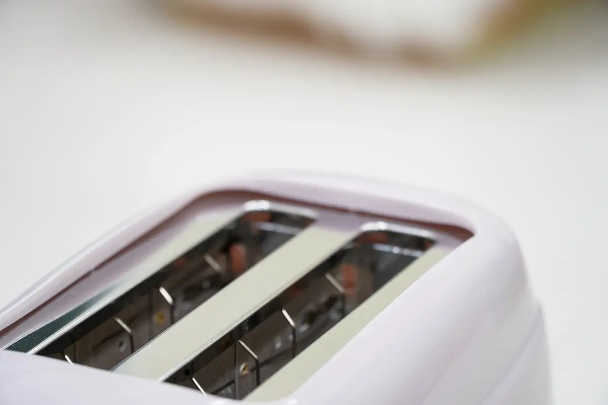 Toast bread in pink toasterisolated on white background