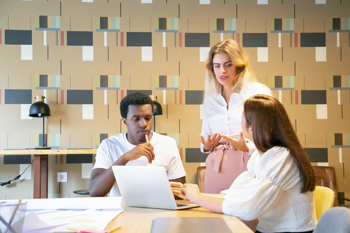Diverse designers discussing project with team leader
