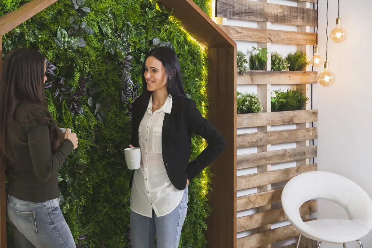 Women resting with cups in office