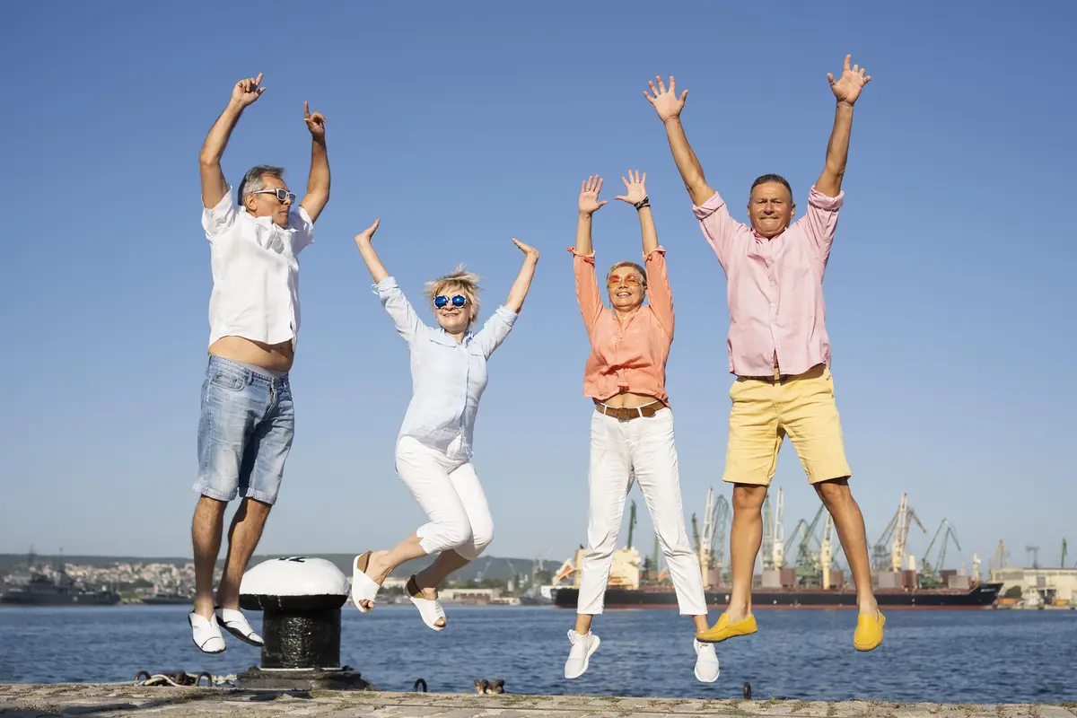 Full shot couples jumping together