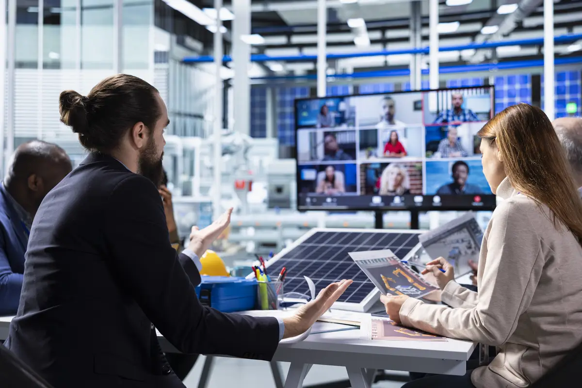 Photovoltaics factory managers look over schematics during online videocall