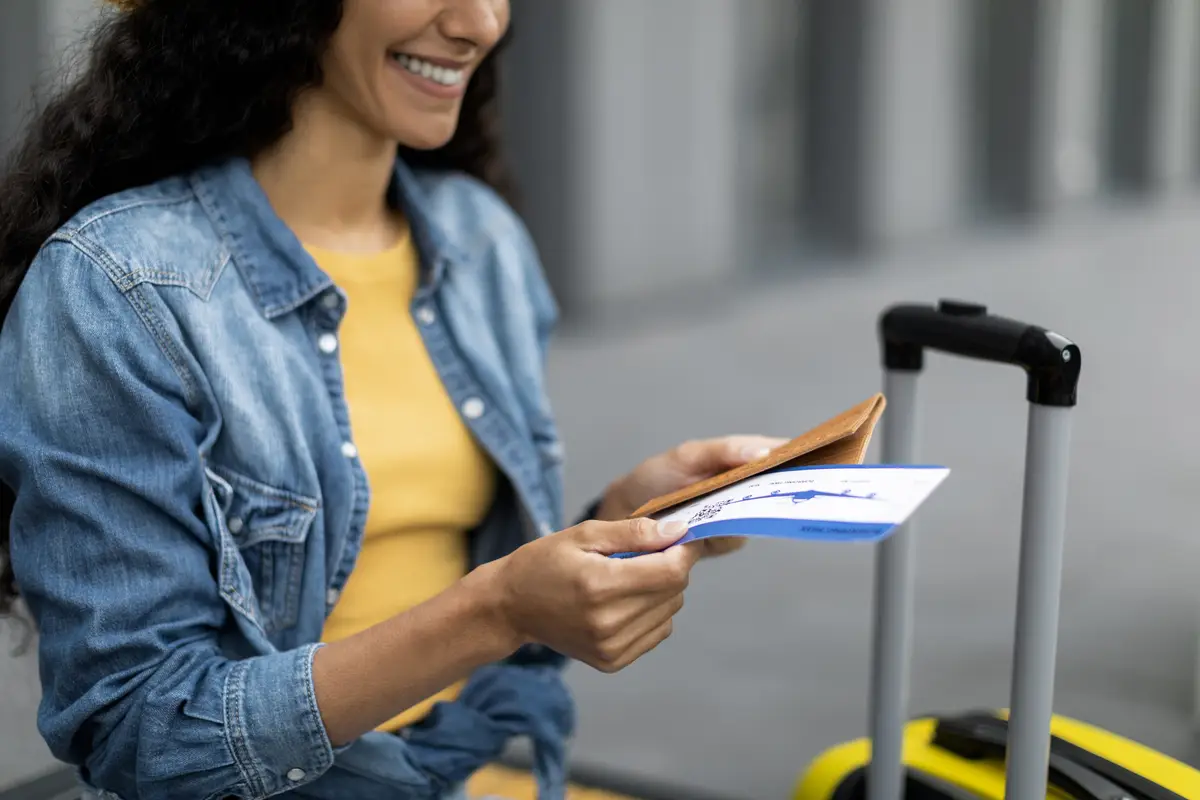 Cropped of female tourist checking flight tickets