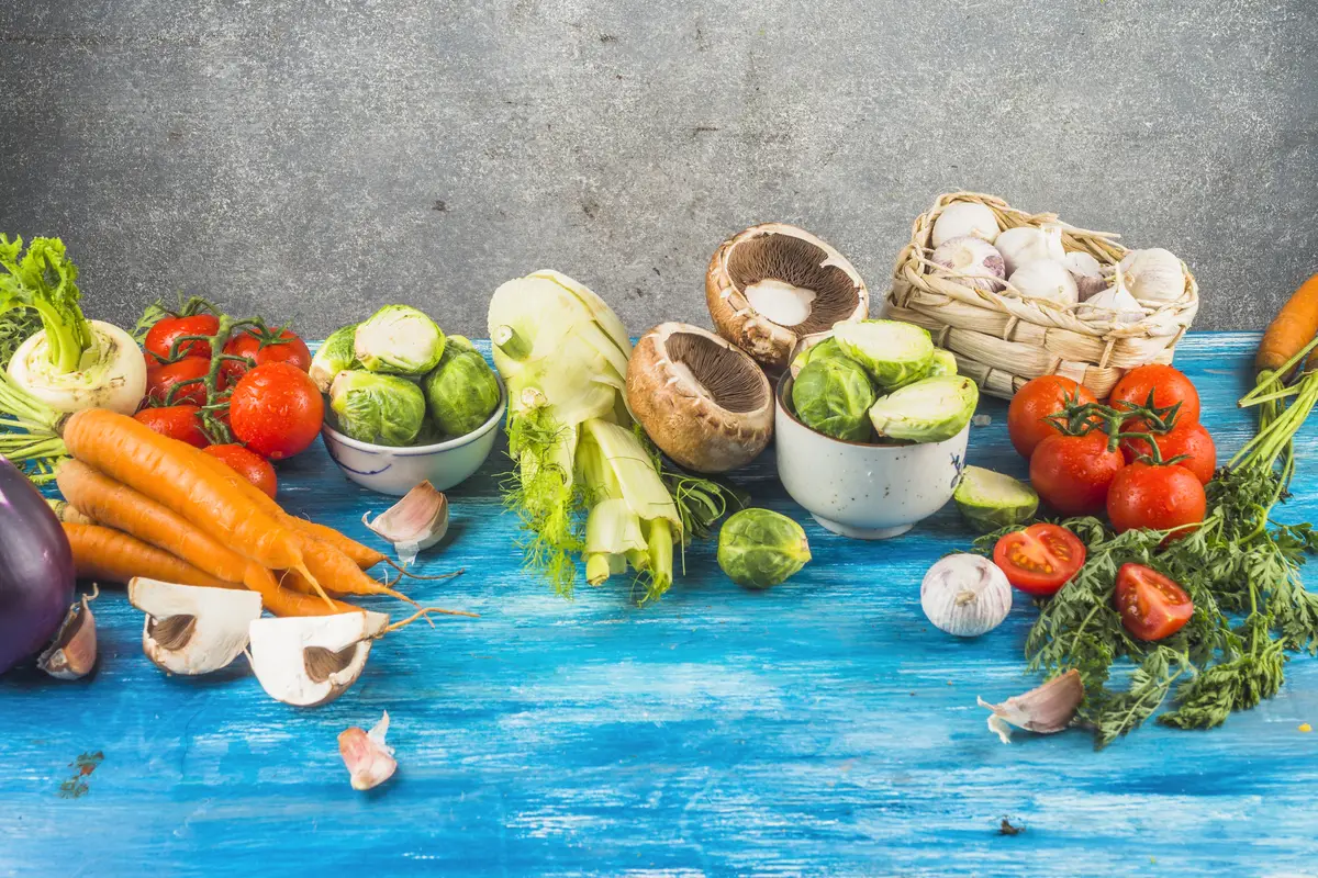 Fresh healthy vegetables on blue wooden tabletop