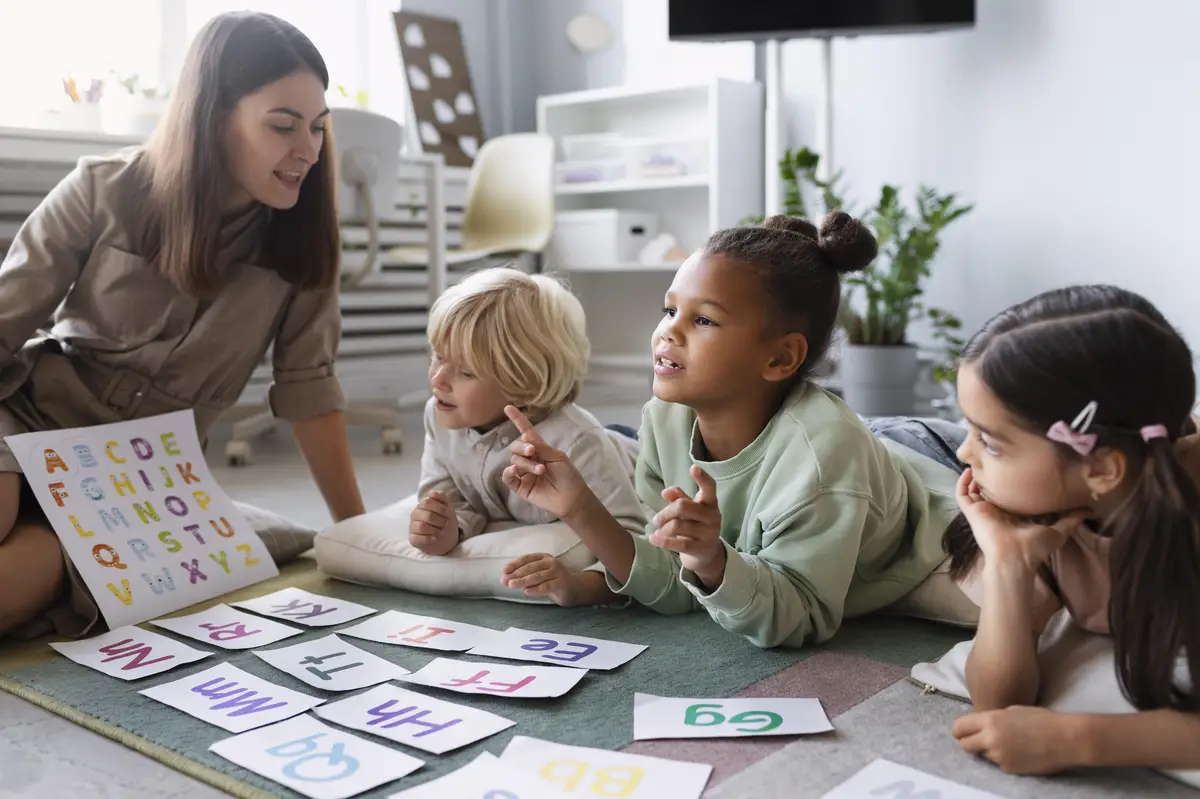 Young woman doing speech therapy with children