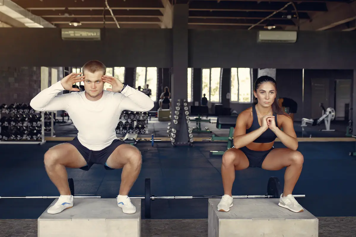 Sports couple in a sportswear training in a gym