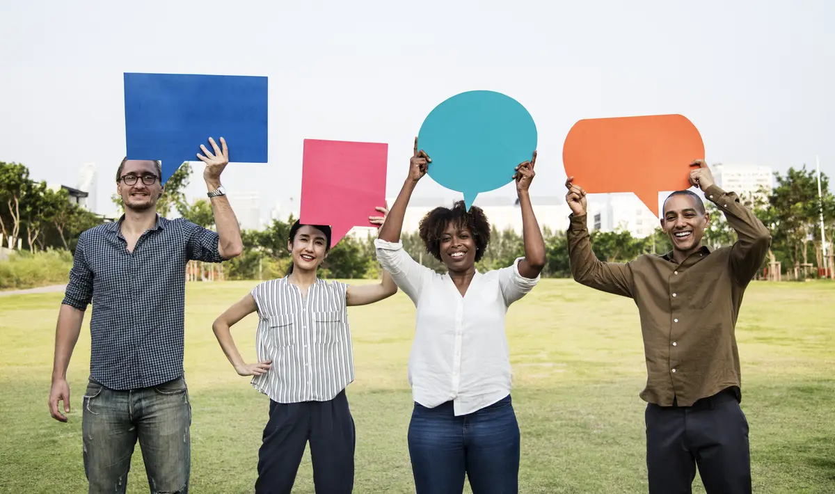 Diverse friends holding speech bubbles