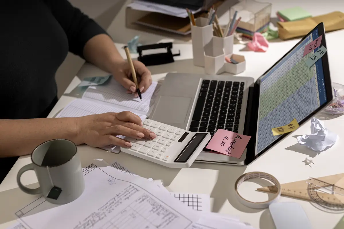 View of messy office workspace with laptop