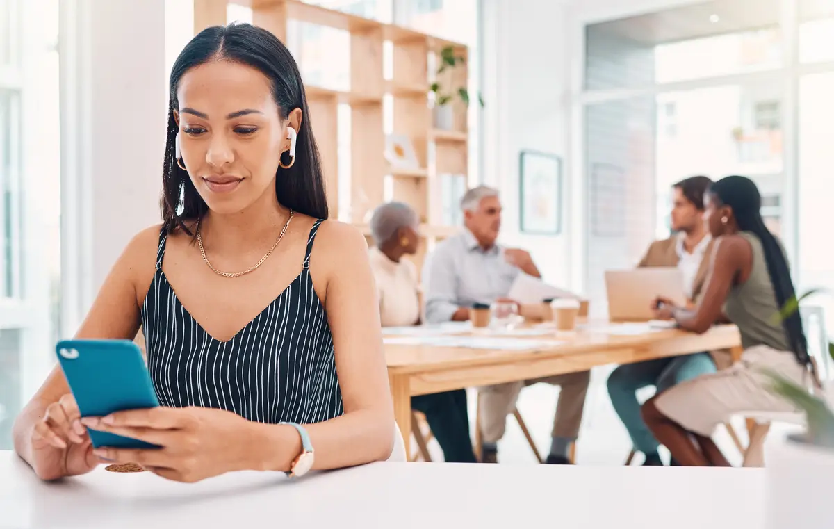Office technology and business woman with phone at desk for networking social media and online research Communication smartphone and female worker typing listening to music and writing email