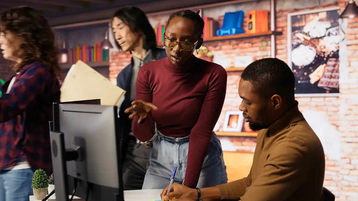 Teamworking startup engineers writing message on sticky notes