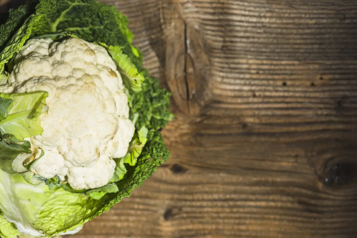 High angle view of cauliflower on wooden background