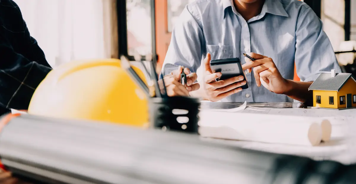 architect man working with laptop and blueprintsengineer inspection in workplace for architectural plansketching a construction project selective focusBusiness concept vintage color