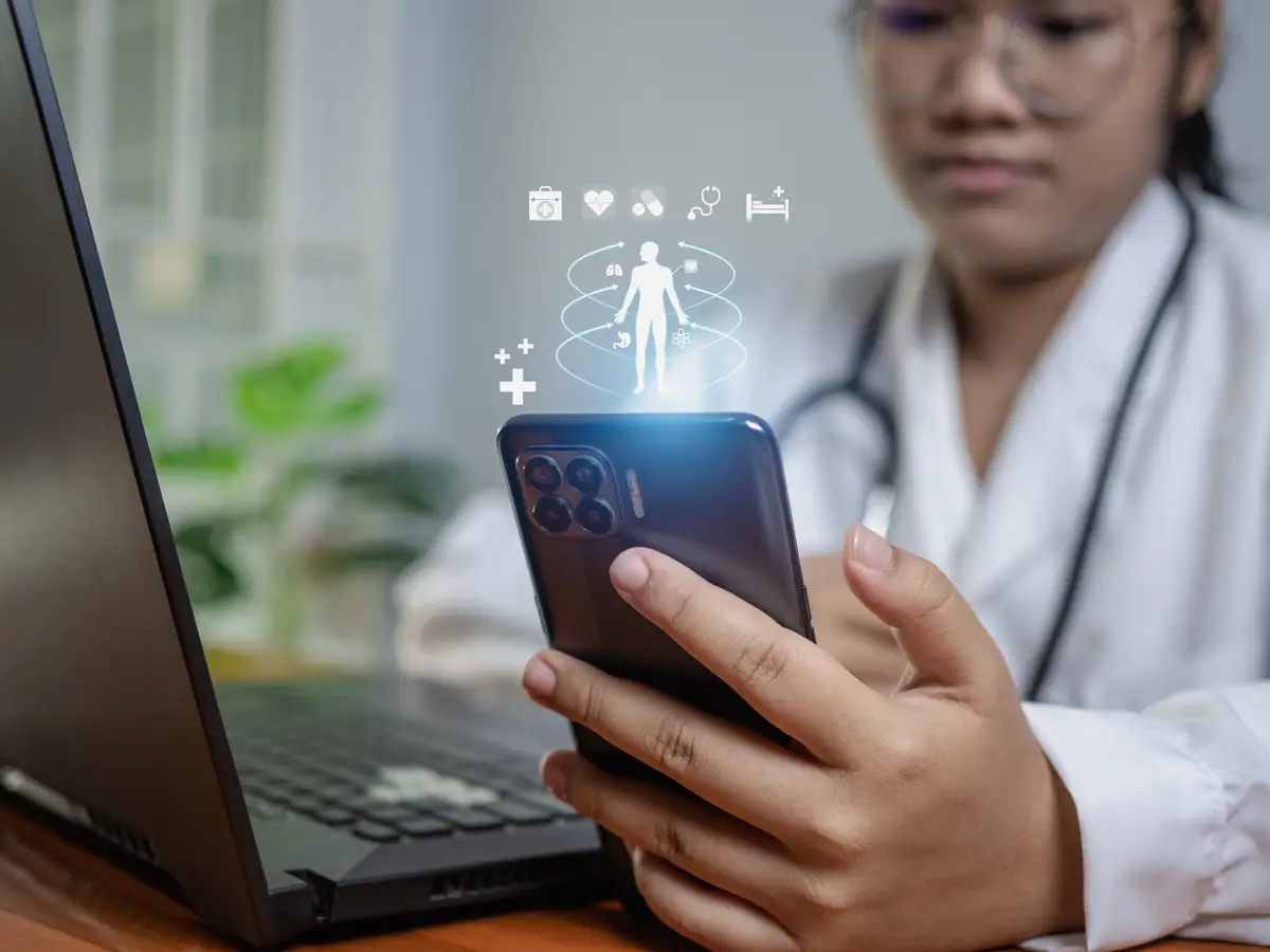 Doctors use smartphones and computers to research medical information medical concept