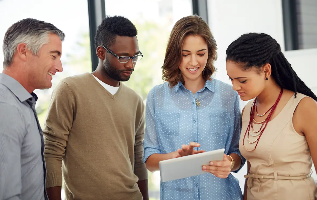 Business people tablet and team with planning in office diversity and reading with brainstorming at startup Woman group and digital touchscreen with application with feedback at creative agency