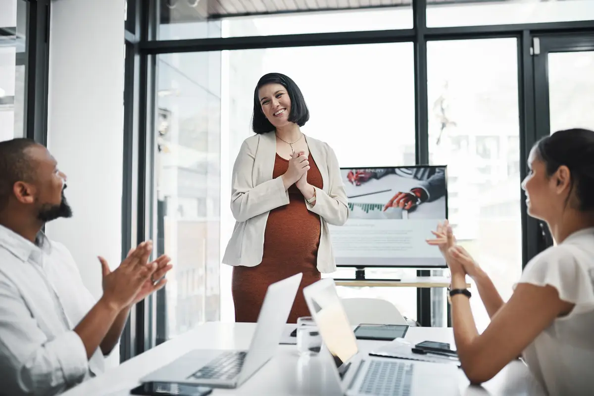 Meeting pregnancy and businesswoman with applause in office with presentation for finance revenue statistics Discussion clapping hands and pregnant female financial presenter with employees