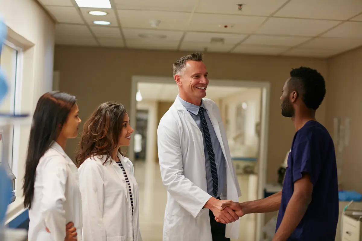 Handshake healthcare or thank you with doctors and nurse in hospital for promotion or welcome Medical meeting and smile of man shaking hands with internship student in clinic for residency success